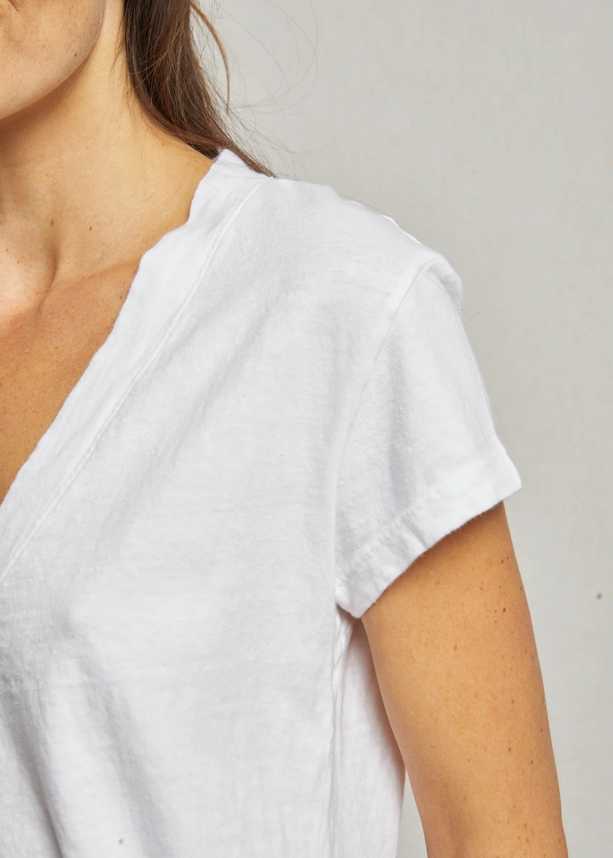 White t-shirt worn by a person on a plain background