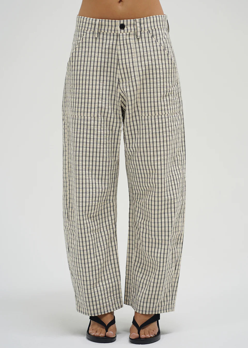 Checkered pants worn by a person on a white background
