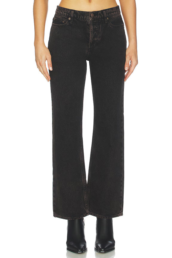 Black flared jeans worn by a person on a white background