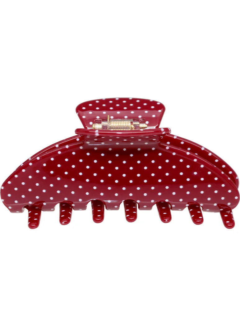 Red polka dot hair clip on a white background