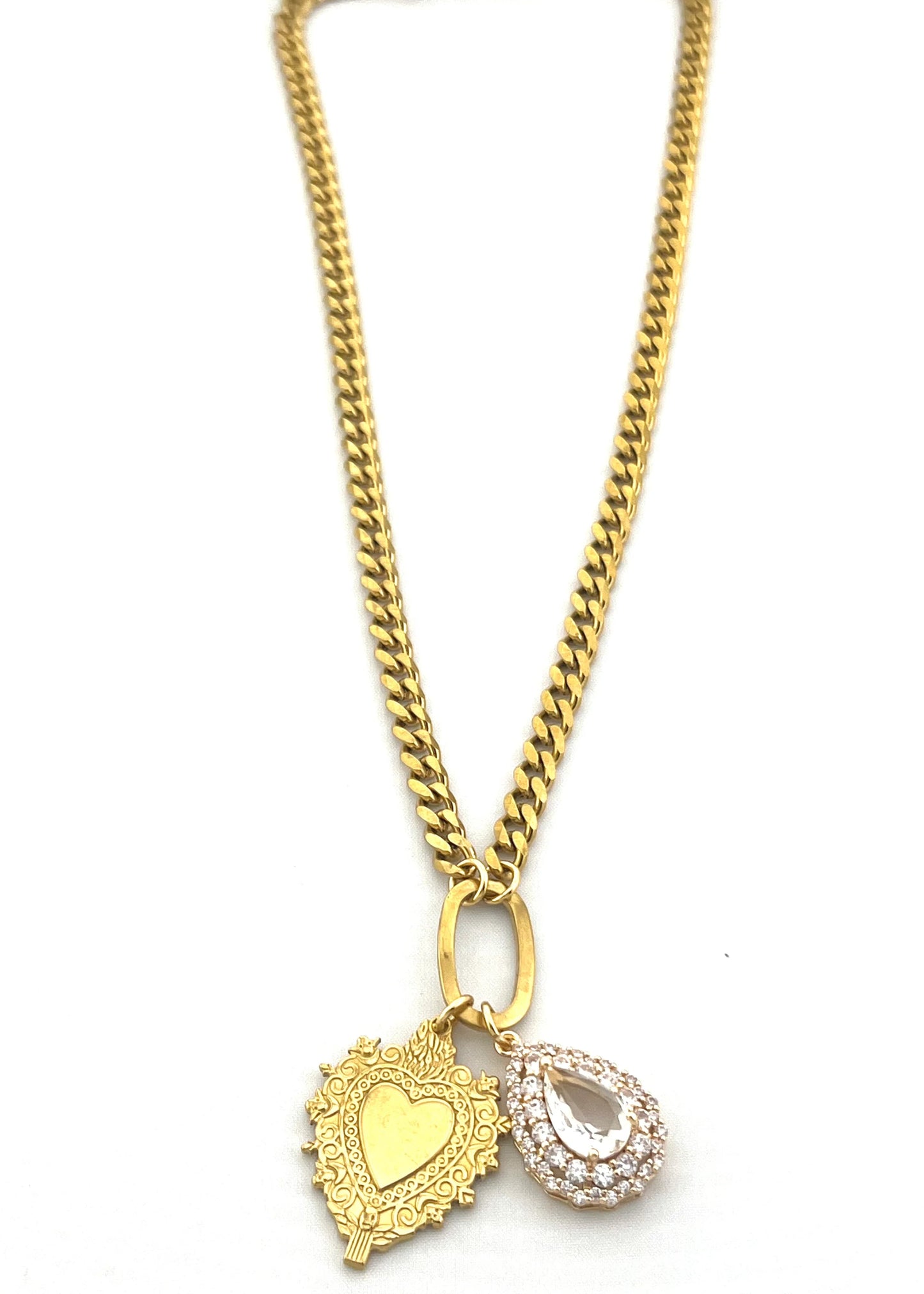 Gold necklace with heart and teardrop pendants on a white background