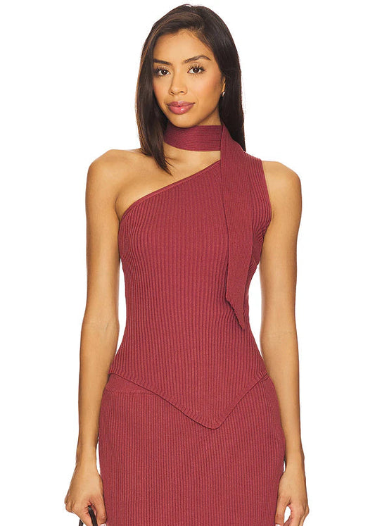 Woman wearing a burgundy ribbed dress on a white background