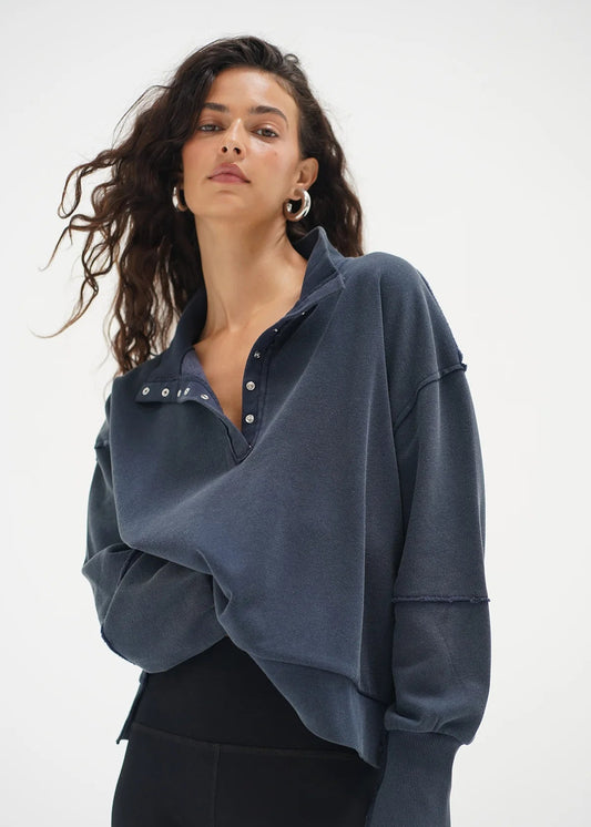 Woman wearing a blue oversized shirt with a white background