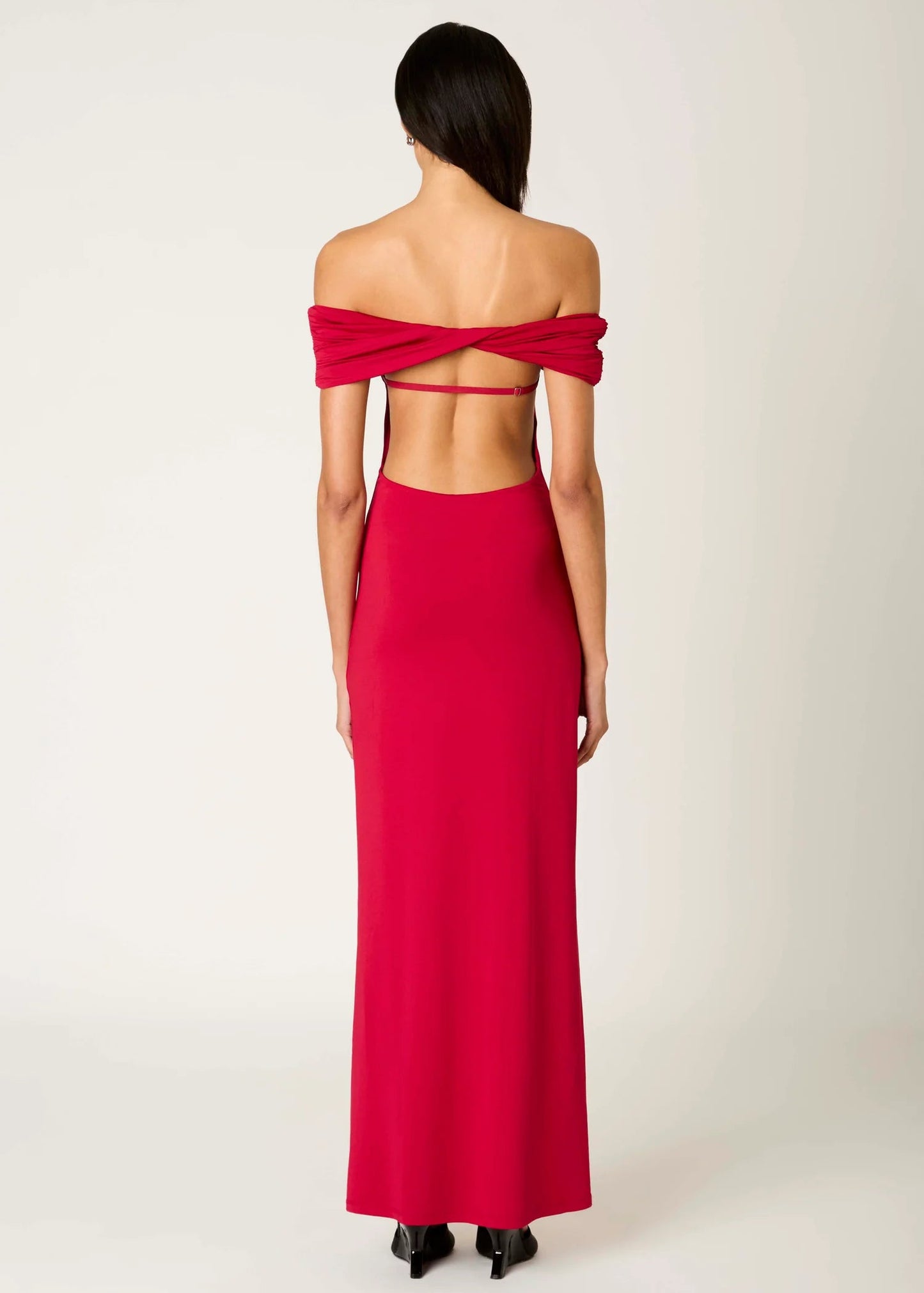 Red off-shoulder gown with cut-out design on a white background