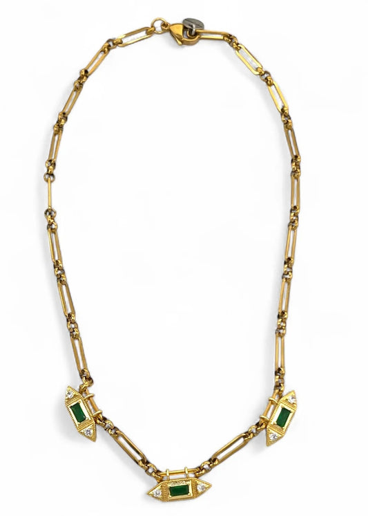 Gold necklace with green gemstones on a white background