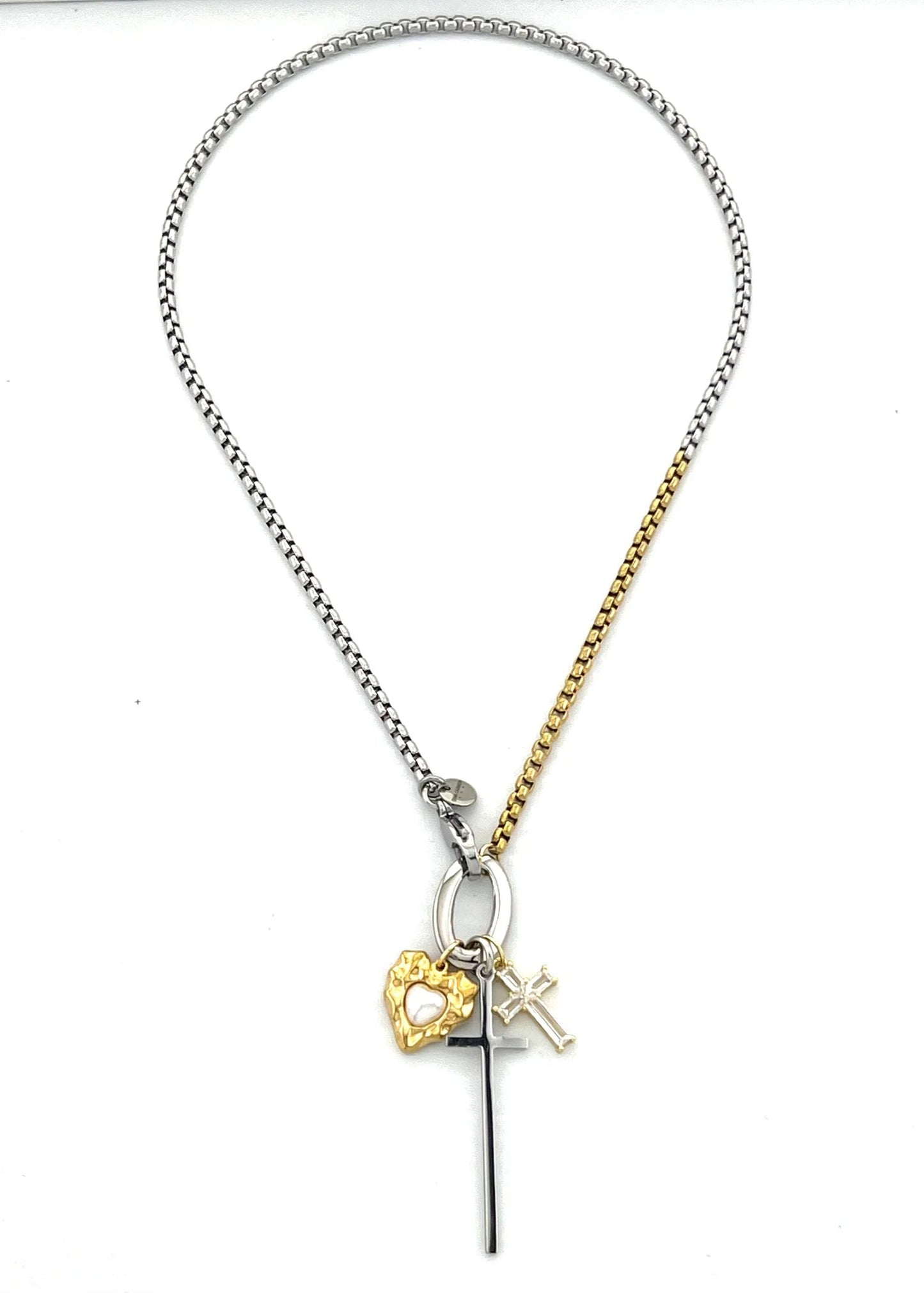 Necklace with heart, cross, and initial charm on a white background