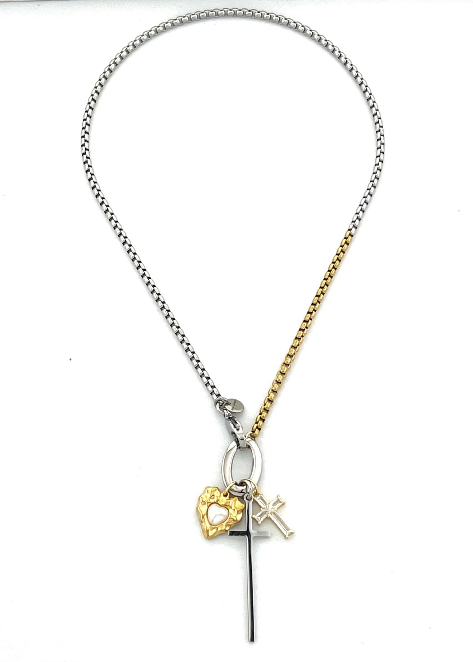 Necklace with heart, cross, and initial charm on a white background