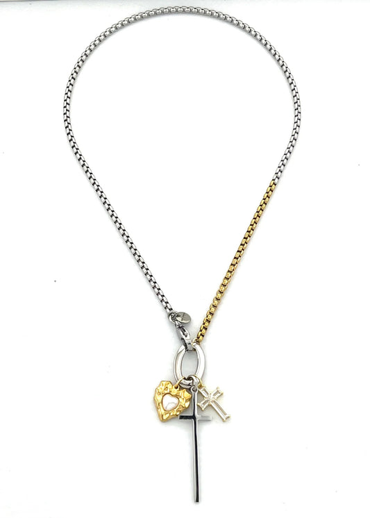 Necklace with heart, cross, and initial charm on a white background