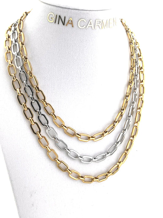 Two gold and silver chain necklaces on a white mannequin with 'Gina Carmi' branding.