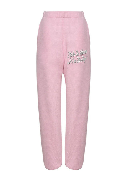 Pink sweatpants with text on a white background