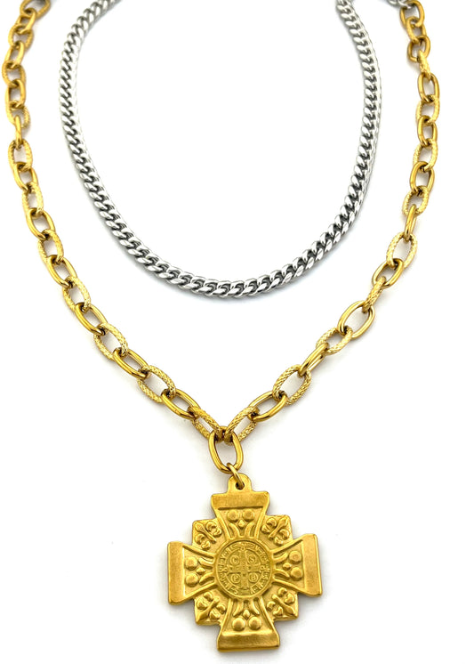 Gold and silver chain necklaces with a gold cross pendant on a white background